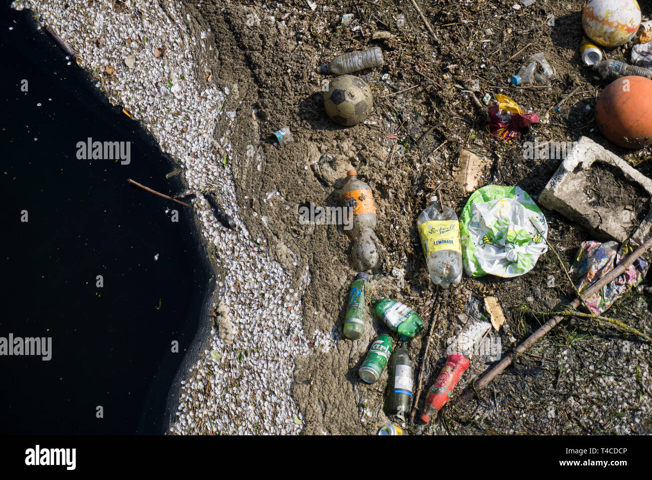 Kunststoffabfälle in die Natur verschmutzen. Müll und Flaschen auf dem Wasser schwimmend Stockfoto