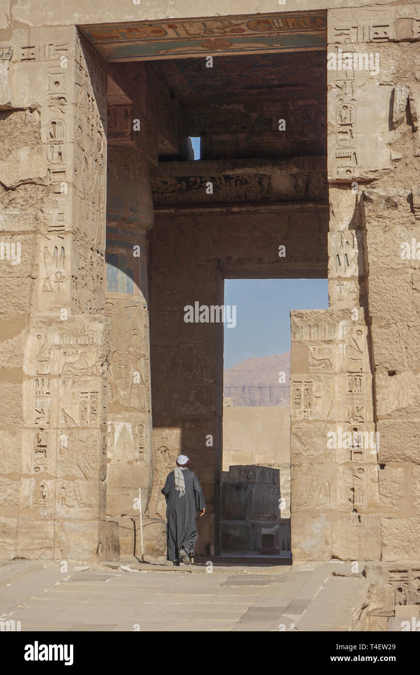 Luxor, Ägypten: der Mann, der in einem traditionellen Ägyptischen Gewand (jellabiya) in Medinet Habu, der Totentempel von Ramses III. auf dem Westufer des Nil. Stockfoto