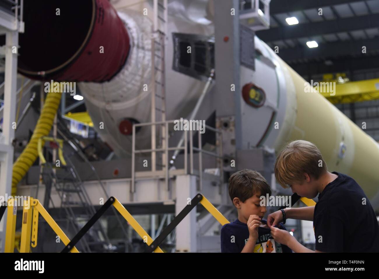 Chase und Seth Stift auf einer kleinen Rakete vor der United Launch Alliance Delta IV-Rakete booster während der 45Th Space Wing Tag der Familie selbst geführte Tour der Cape Canaveral Air Force Station, Fla. Am 6. April 2019. Tag der Familie hatte mehrere Betriebs- und historische Anzeigen von Standorten, die 45Th Space Wing Familien die Möglichkeit gab zu sehen und über Cape Canaveral lernen. Stockfoto