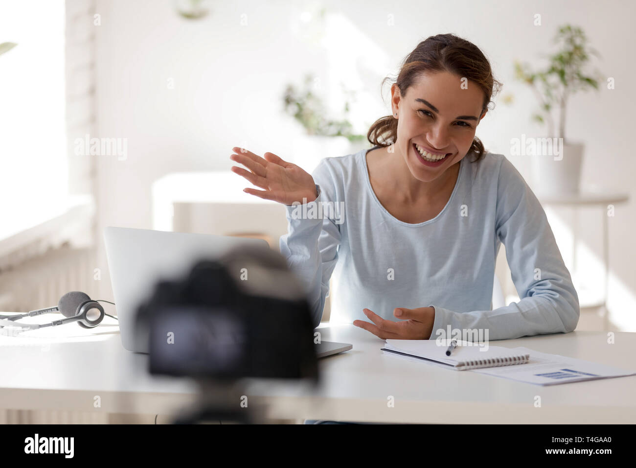 Schöne Frau winkte lächelnd ihre Hand an Kamera suchen Stockfoto