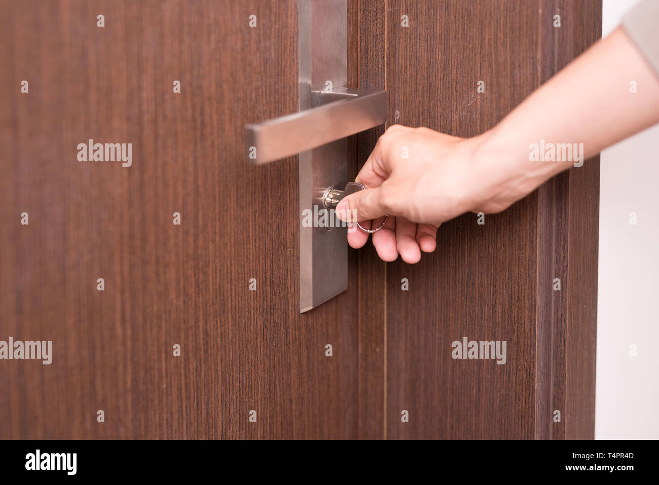 Männliche Hand öffnen Sie eine Tür mit einem Schlüssel. Stockfoto