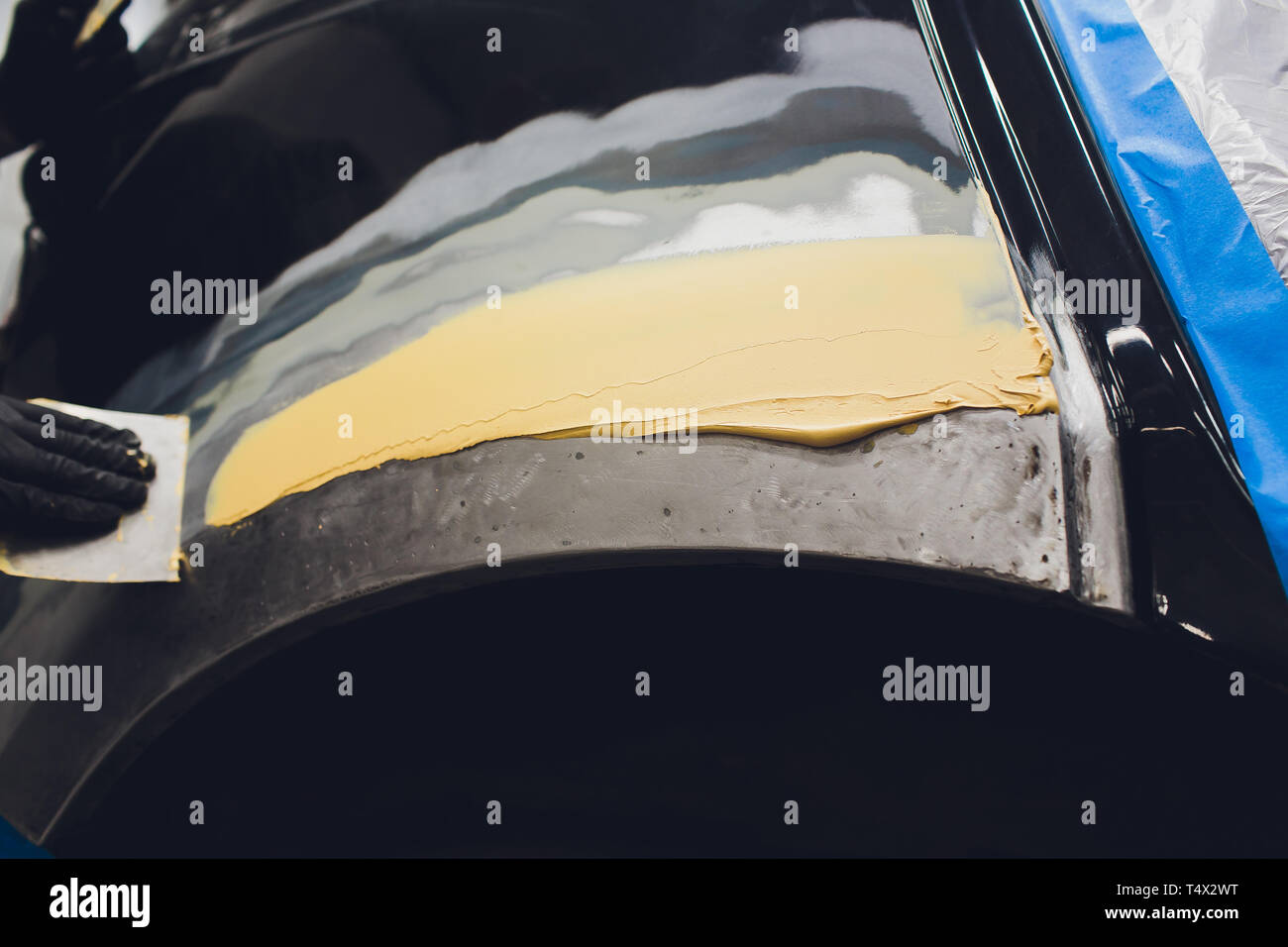 Vorbereitung für die Lackierung eines Autos mit schmirgel Absender ein Service Techniker, Nivellierung, bevor Sie eine Grundierung nach der Beschädigung auf einen Teil des Bsb Stockfoto