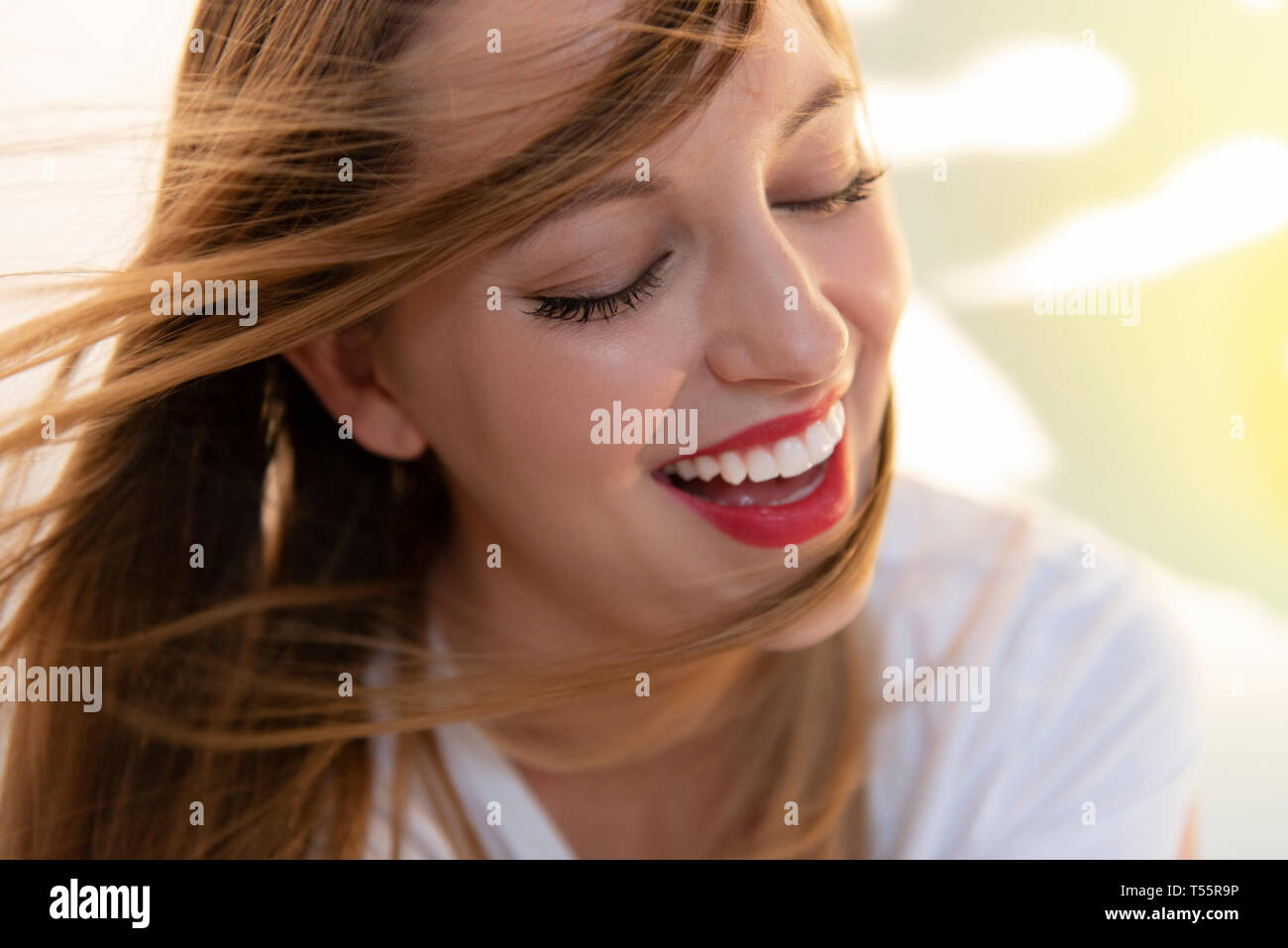 Portrait von windswept junge Frau das Tragen der roten Lippenstift Stockfoto