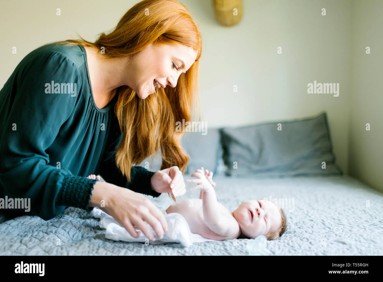 Frau ändern ihren neugeborenen Sohn die Windeln Stockfoto