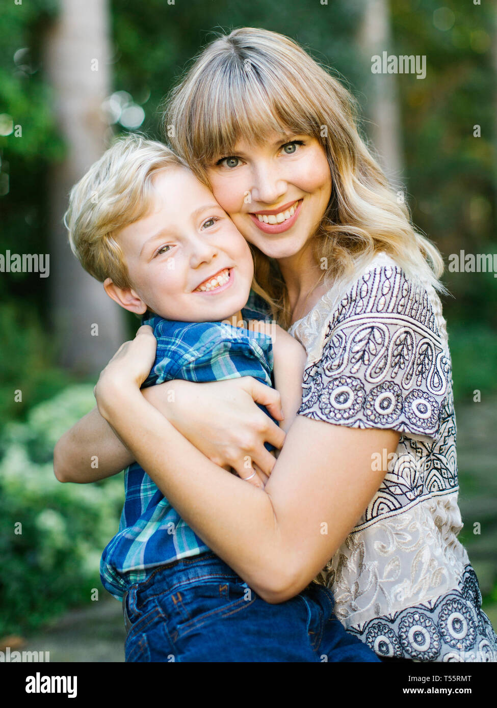 Lächelnde Mutter und Sohn umarmen Stockfoto