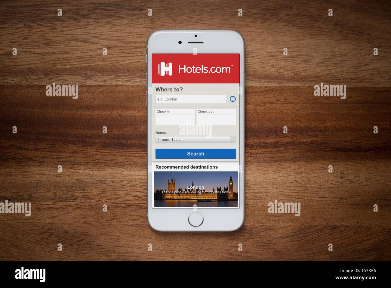 Ein iPhone mit Hotels.com Website beruht auf einem einfachen Holztisch (nur redaktionelle Nutzung). Stockfoto