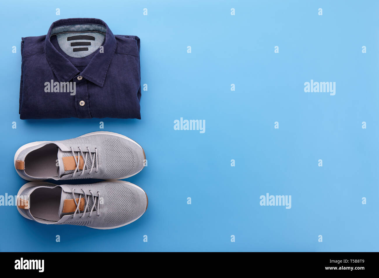 Mens Sommer Freizeitkleidung Outfits und Zubehör flach auf blauem Hintergrund legen, Ansicht von oben Stockfoto