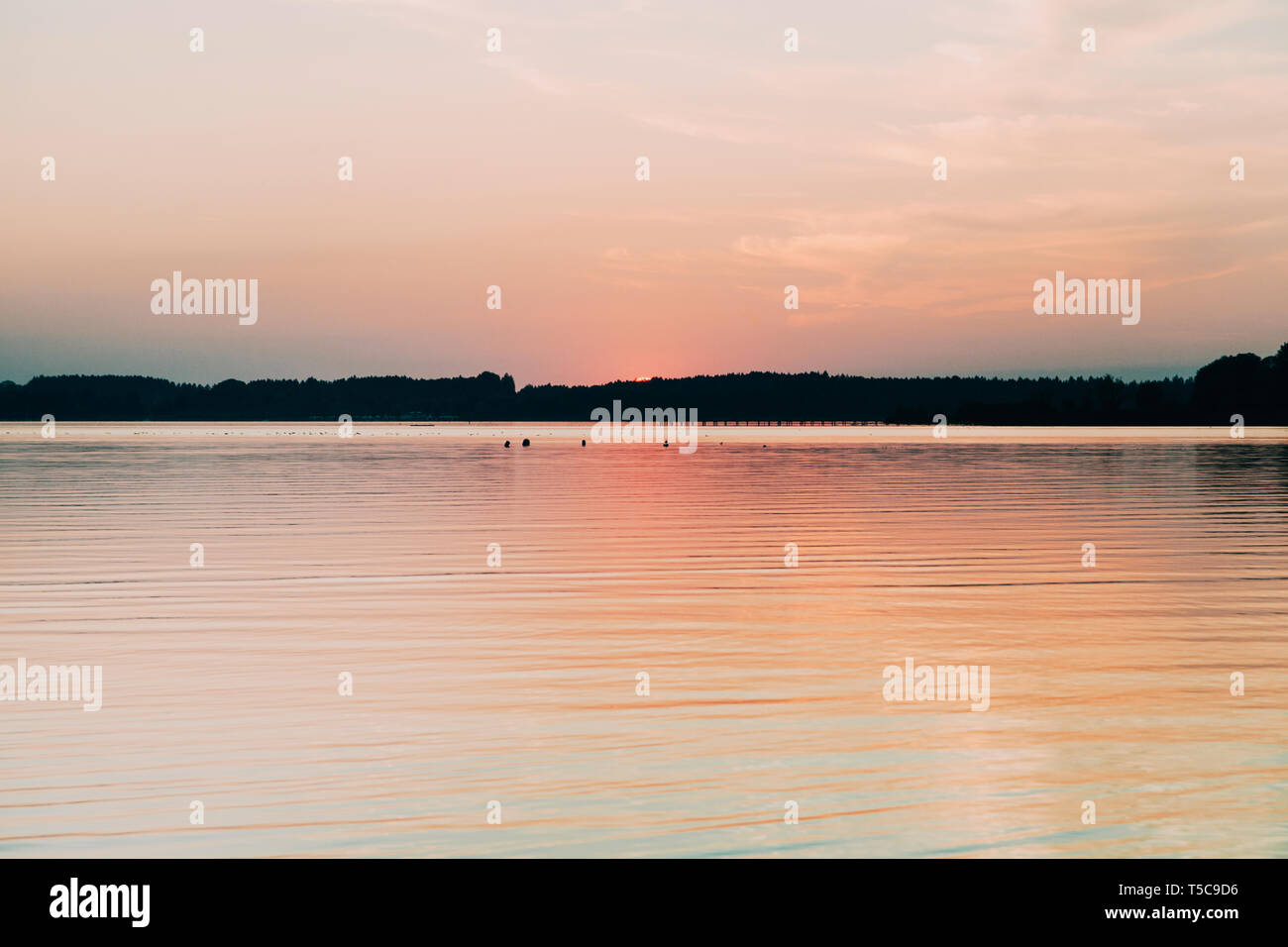 Sonne versteckt sich hinter dem Horizont im See der Chiemsee Stockfoto