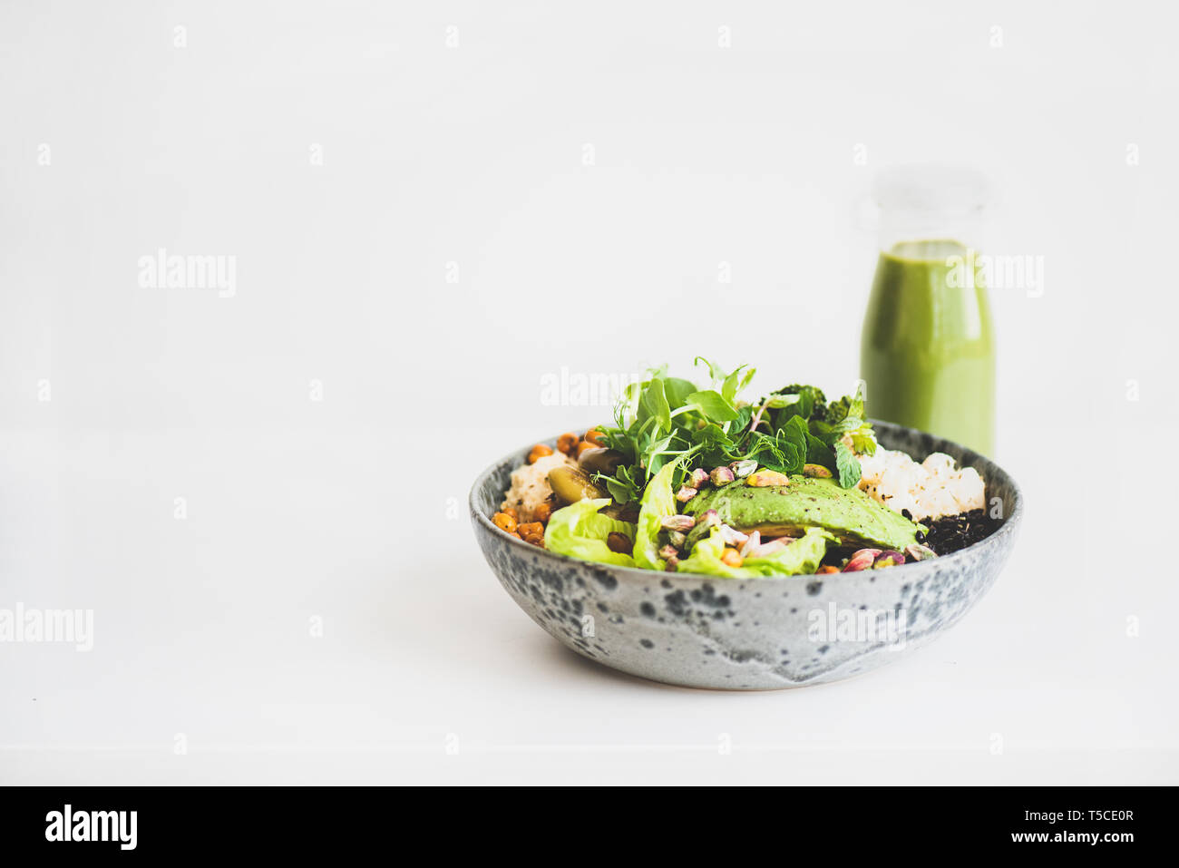 Gesund vegan Superbowl mit Hummus und grünen Smoothie Stockfoto