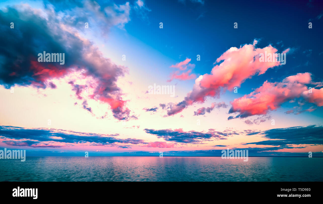Schönen Sonnenuntergang Wolken über dem Horizont mit Reflexionen Stockfoto