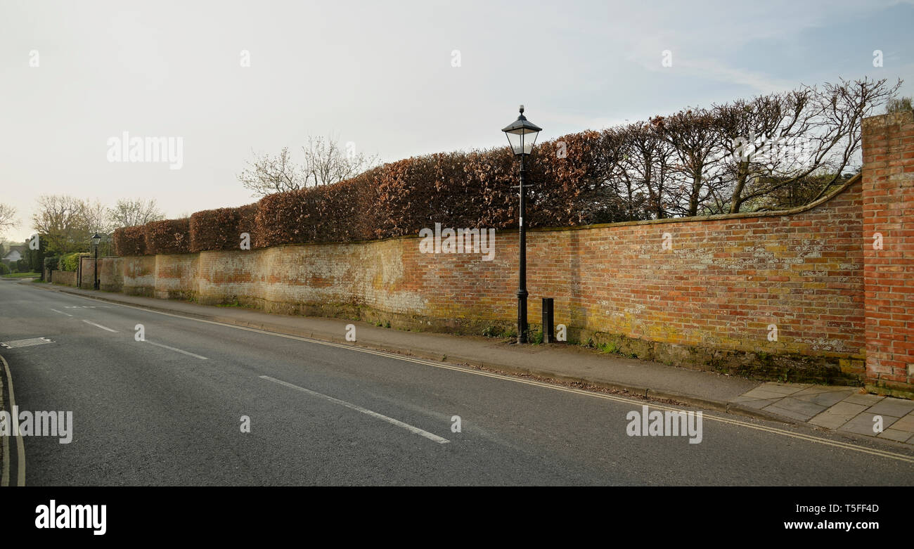 Ungewöhnlich wellenförmige Wand konzipiert. Wohn- Garten mit gebogenen Red brick wall. Stockfoto