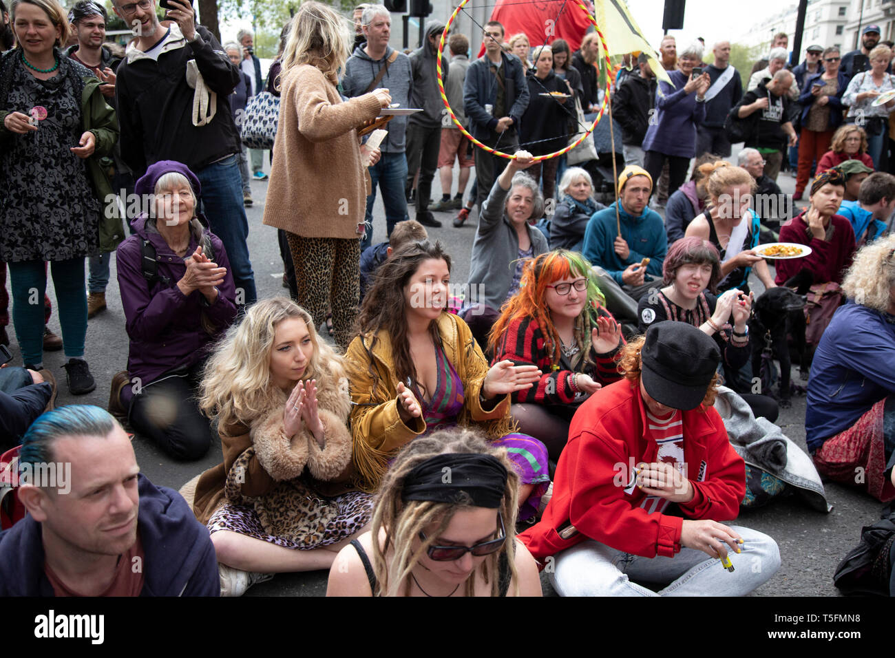 Klimawandel Aktivistinnen aus dem Aussterben Rebellion Gruppe singen Lieder als Polizei beginnen zu reden und zu versuchen, die Oxford Street in der Nähe des Marble Arch Camp aus Protest, dass die Regierung nicht genug um die katastrophalen Klimawandel zu vermeiden und zu verlangen, dass sie die Regierung radikale Maßnahmen zu ergreifen, um den Planeten zu retten, die am 24. April 2019 in London, England, Vereinigtes Königreich. Aussterben Rebellion ist ein Klimawandel Gruppe begann im Jahr 2018 und hat eine riesige Fangemeinde von Leuten zu friedlichen Protesten begangen. Stockfoto