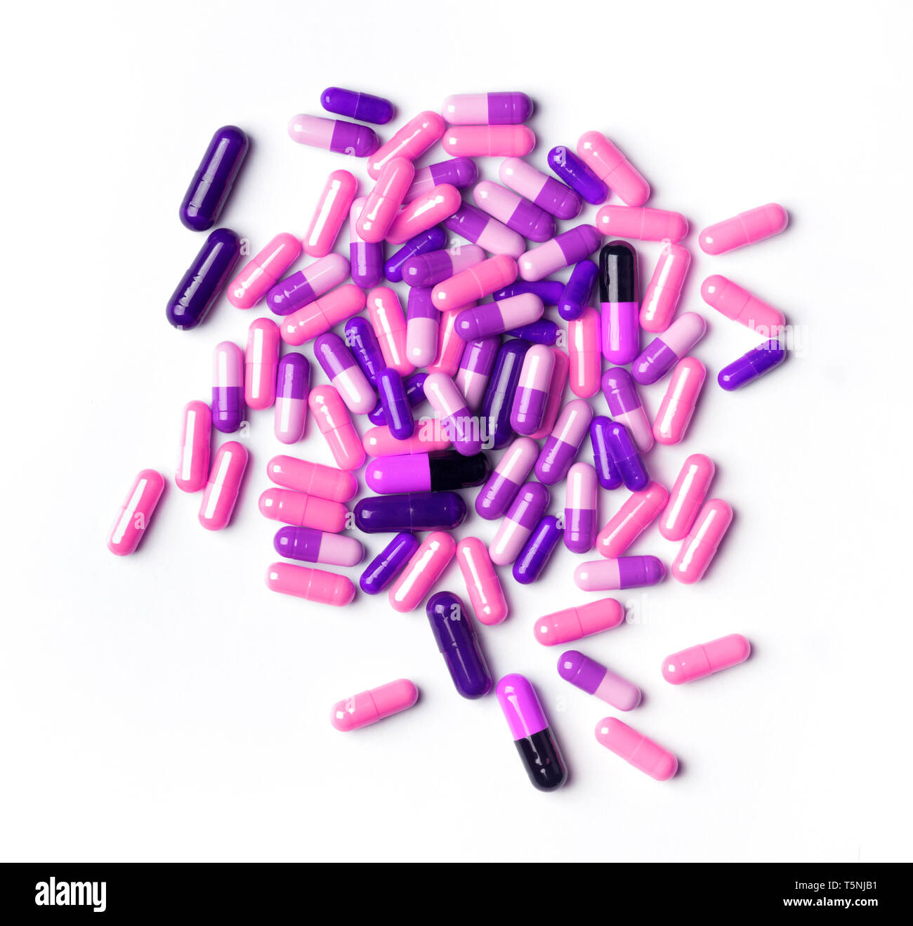 Blick von oben auf die Stapel der Farbe rosa Pillen gegen den weißen Hintergrund. Medizin Missbrauch Konzept Stockfoto