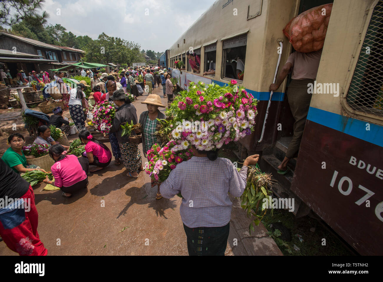 Blumenverkäufer auf der Plattform von einem Bahnhof auf dem Weg nach Thazi, Myanmar. Stockfoto