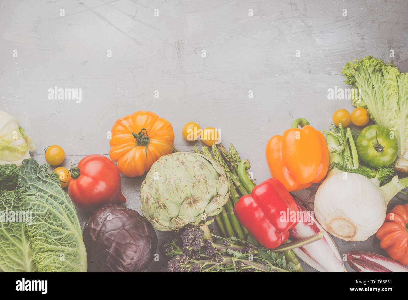 Frisches rohes Gemüse, Kohl Karotten Pfeffer Fenchel Broccoli Spargel Tomaten Salat artichocke, auf Grau konkreten Hintergrund, Ansicht von oben, Kopieren, s Stockfoto