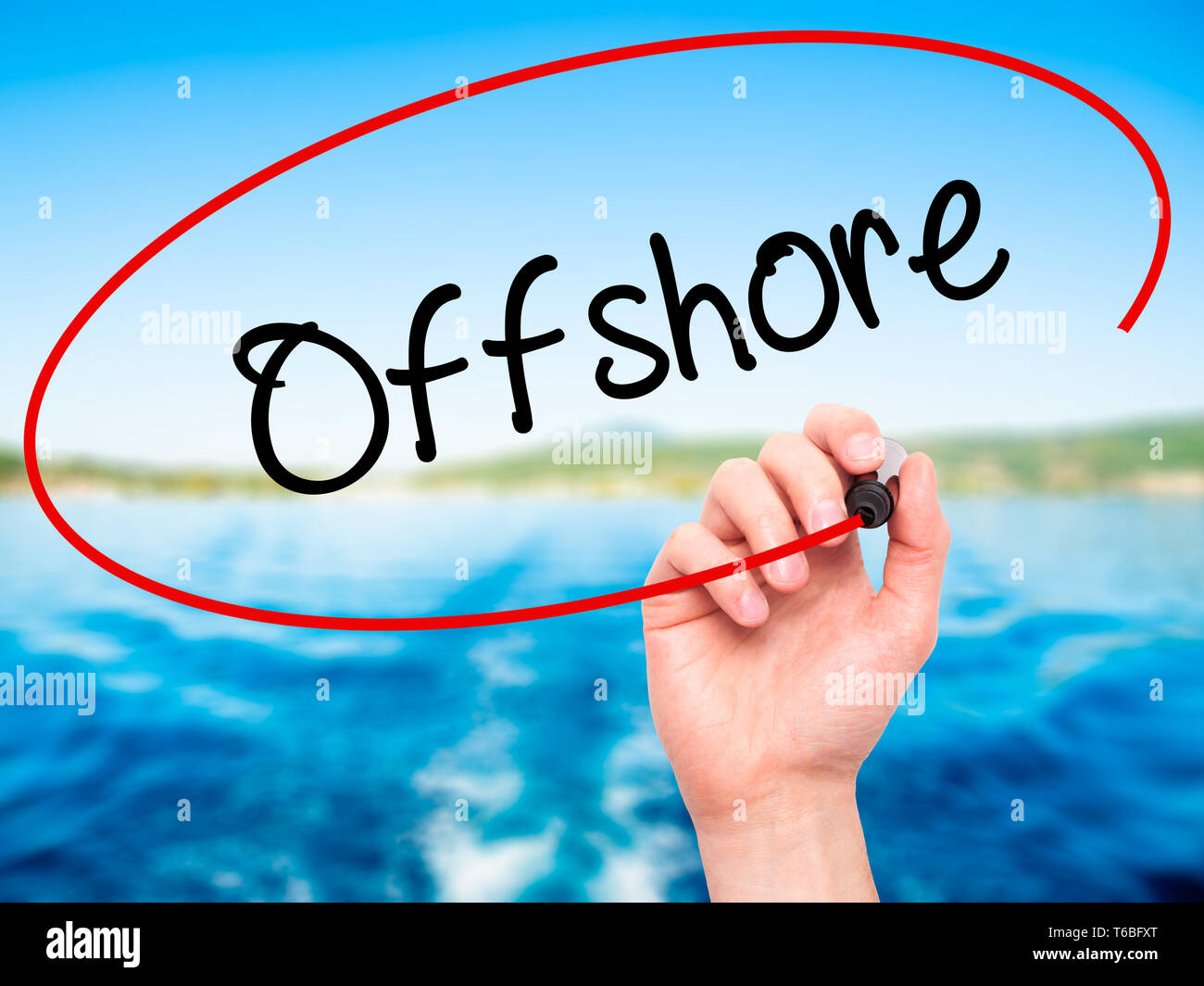 Mann Hand schreiben Offshore mit schwarzem Marker auf visuelle Bildschirm Stockfoto