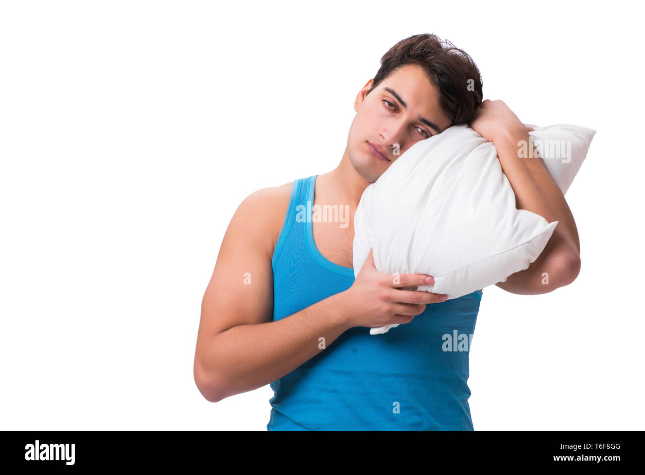 Junger Mann mit Kissen auf weißem Hintergrund Stockfoto