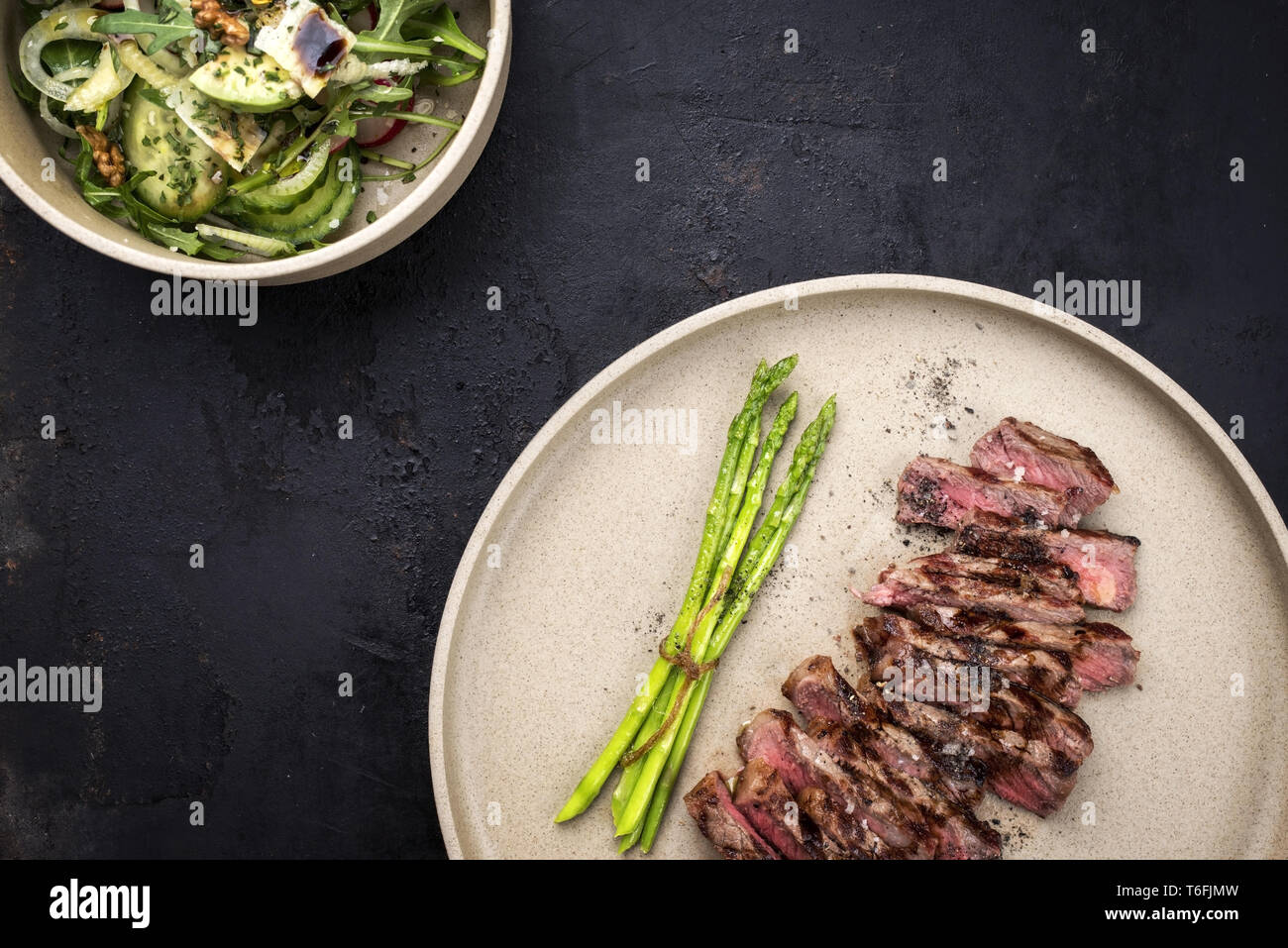Traditionelle Grill skirt Steak mit grünem Spargel und Salat geschnitten als Close-up auf einer Platte Stockfoto