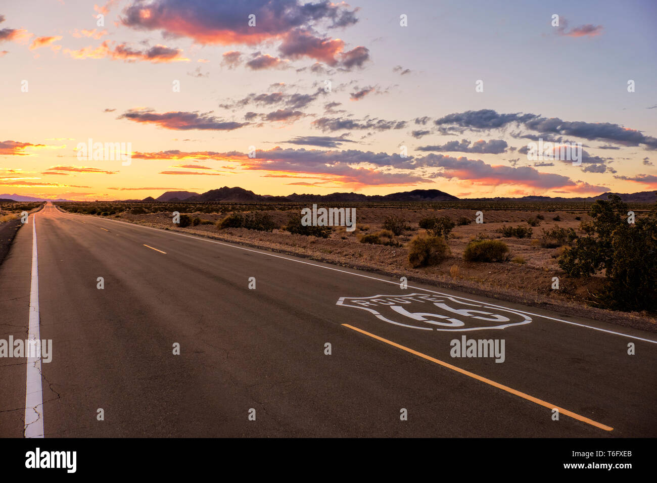 Dramatischer Sonnenuntergang über Route 66 mit der offenen Straße in die Mojave Wüste geht, während auf Ferien Reise in Südkalifornien. Stockfoto