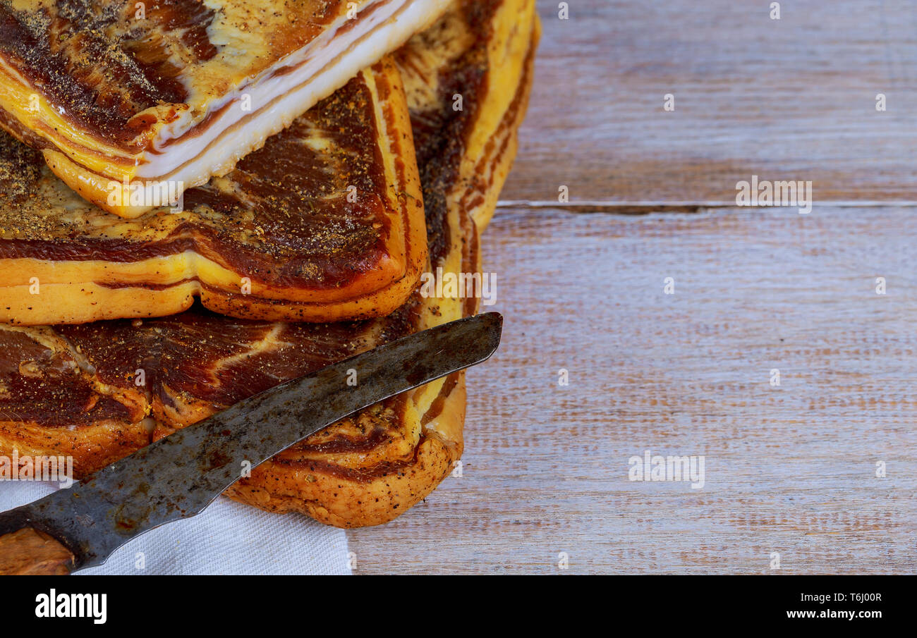 Lecker geräucherten Speck der traditionellen geräucherten Fleisch am Holztisch Stockfoto