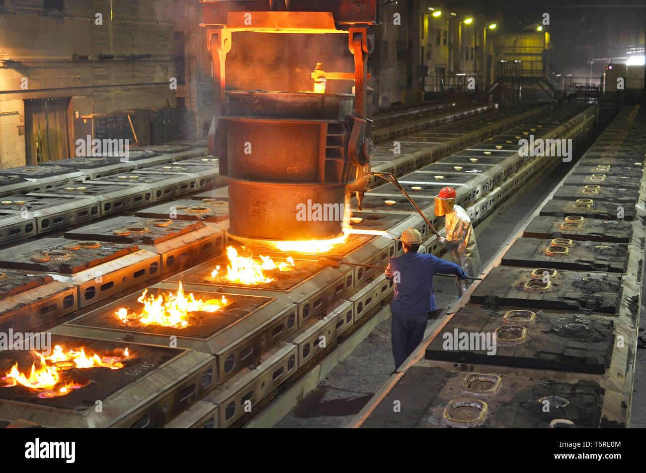 Produktion von Metallkomponenten in einer Gießerei - Gruppe der Arbeitnehmer Stockfoto