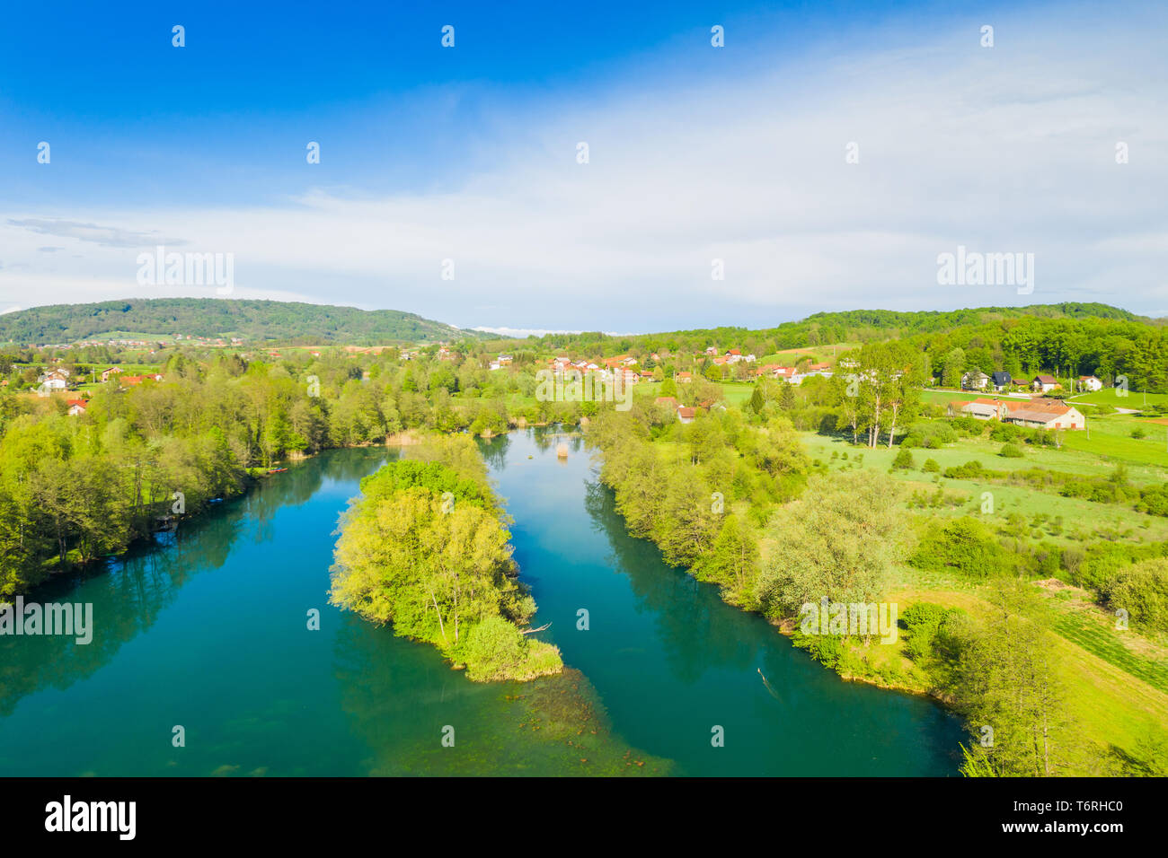 Schöne Landschaft, Kroatisch Fluss Mreznica und Dorf von perna aus Luft, ruhige Wasseroberfläche und Holz Stockfoto