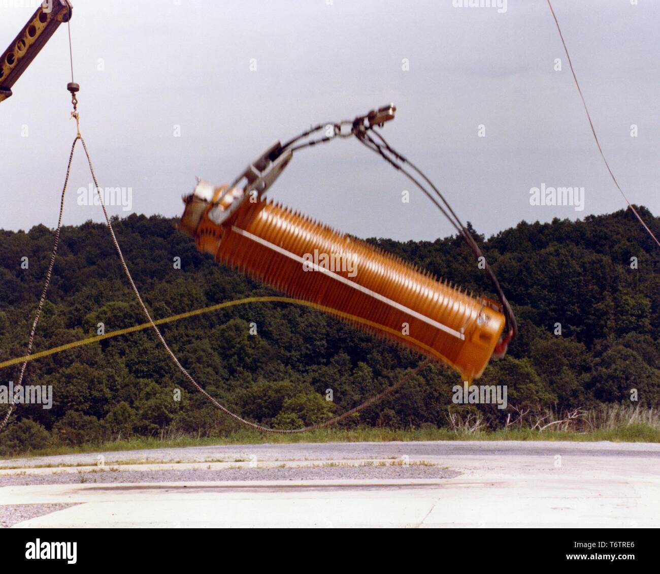 Eine abgebrannte Brennelemente Transportbehälters fällt zu Boden während eines Drop Test in einem Waldgebiet, 1975. Mit freundlicher Genehmigung des US-Ministeriums für Energie. () Stockfoto