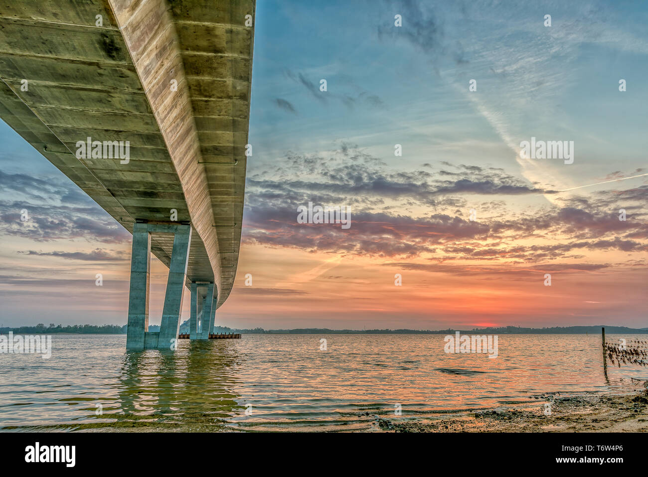 Die Unterseite der Kronprinzessin Mary Bridge, und die Sonne und die roten Wolken sind im Wasser, Frederikssund, Dänemark, 30. April 2019 widerspiegeln Stockfoto