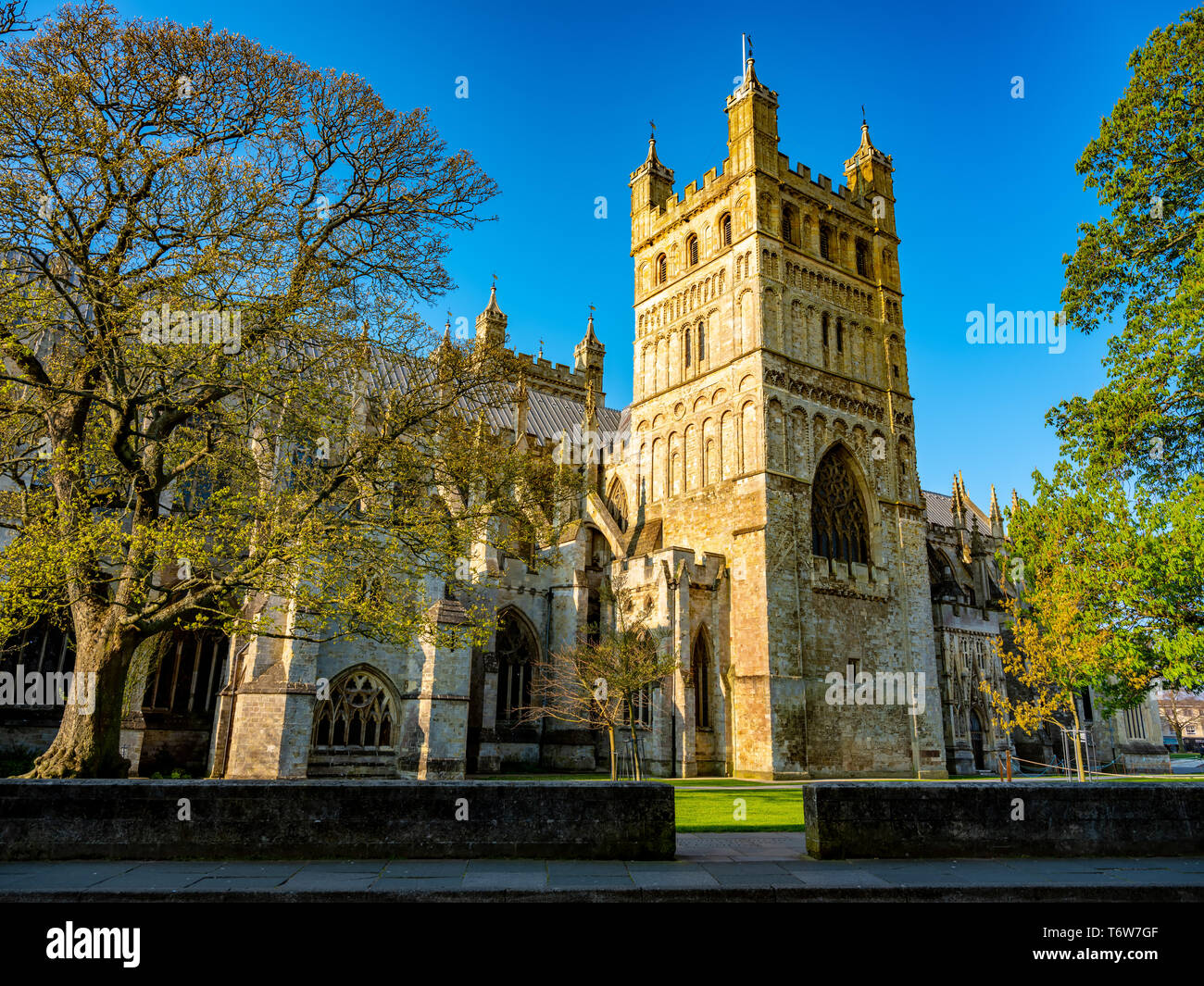 Die berühmte Kathedrale von Exeter. Die Hauptattraktion der Stadt. Frühen Sommermorgen. Die Wände sind durch die geringe aufgehende Sonne beleuchtet. Exeter. Devon. Stockfoto
