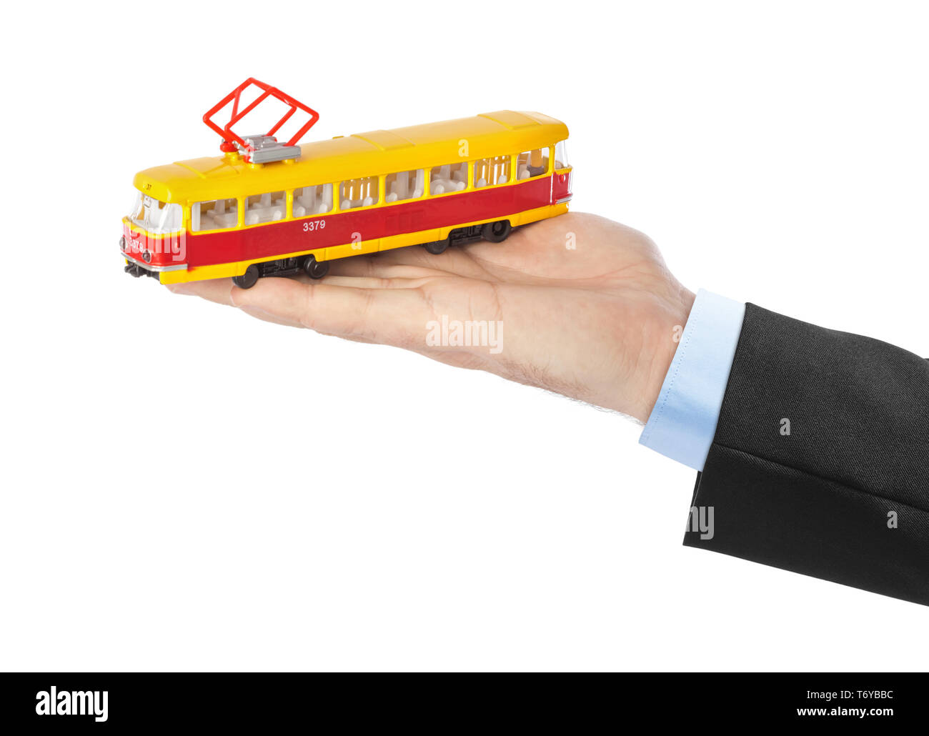 Hand mit Spielzeug Straßenbahn Stockfoto