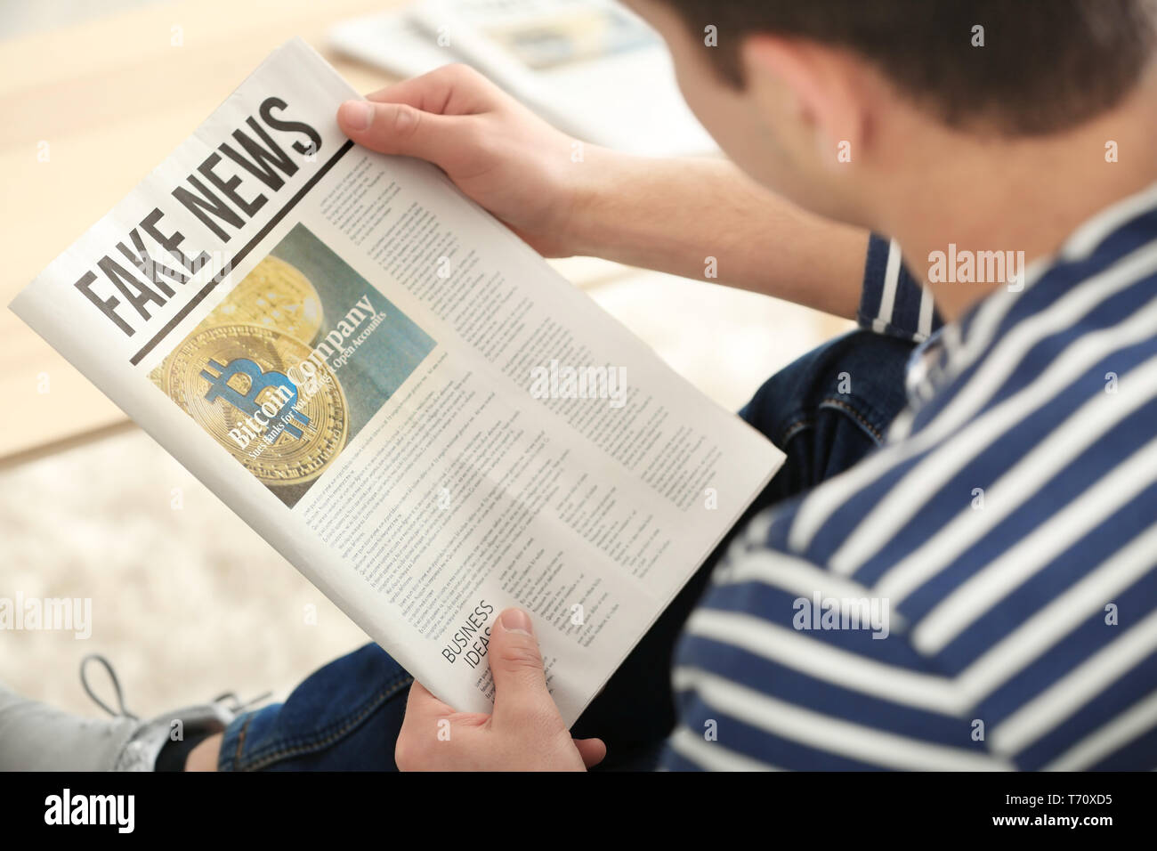 Schöner mann lesen Zeitung zu Hause Stockfoto