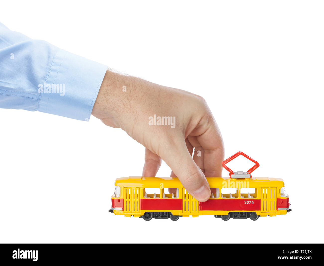 Hand mit Spielzeug Straßenbahn Stockfoto