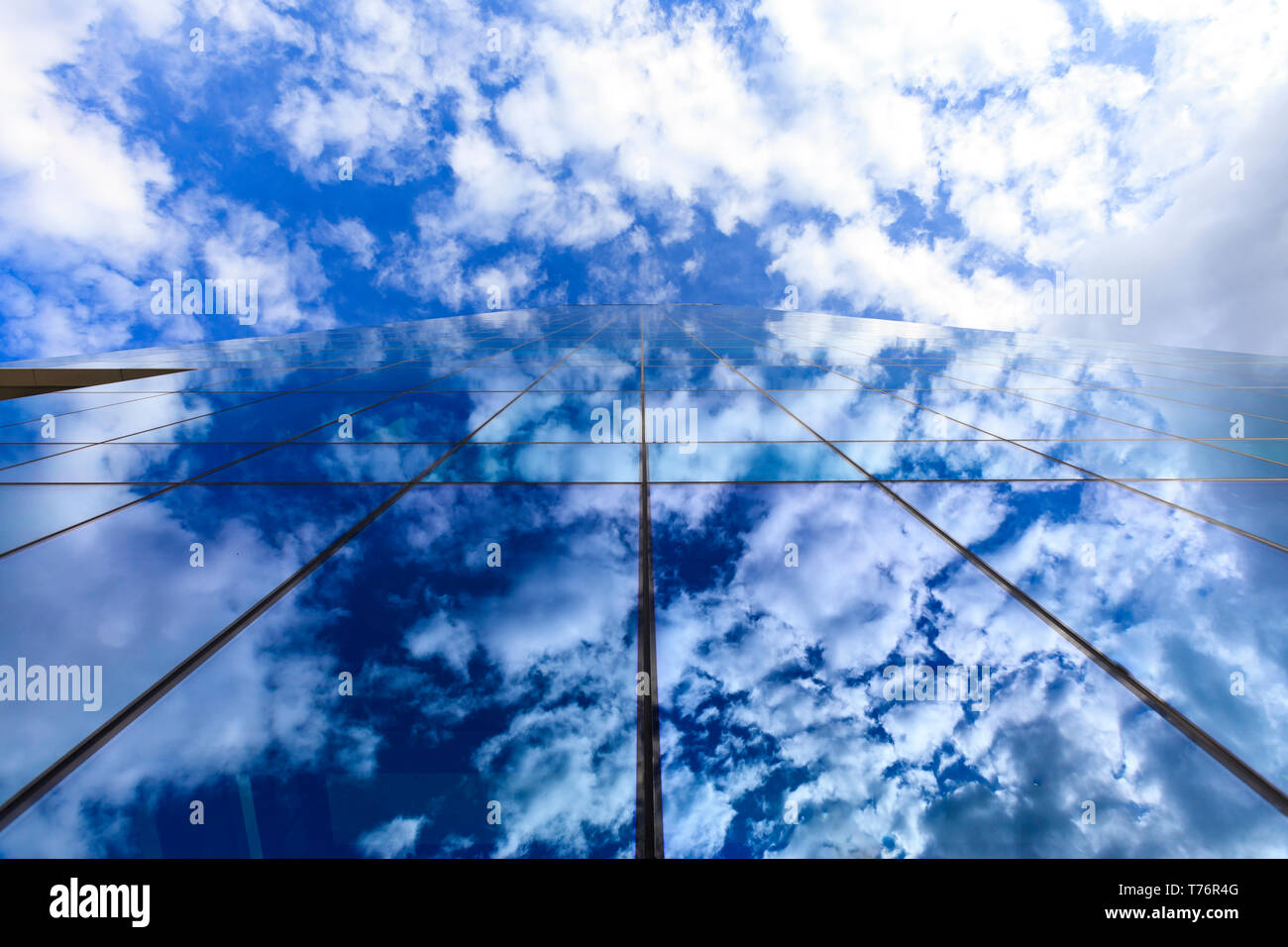 Wolken und blauer Himmel spiegelt sich auf Glas Bürogebäude windows Stockfoto