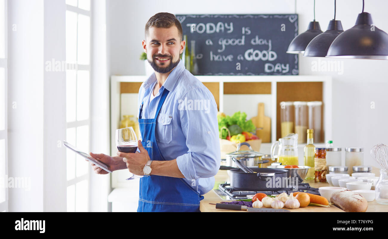 Kochen mit einem Tablett in der Hand und das Studium der Rezeptur. Stockfoto