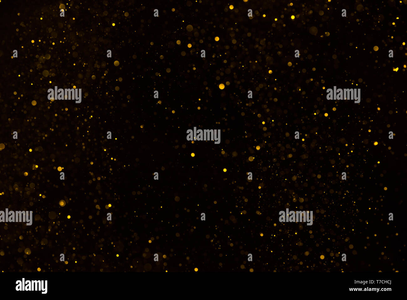 Golden Glitter, Glitzer Hintergrund auf Schwarz Stockfoto