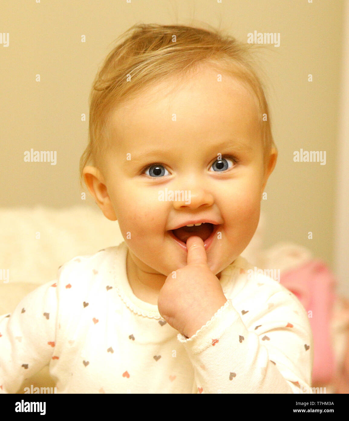 Neugeborene europäischen Baby Mädchen Jungen wundern, mit dem Finger im Mund 12 Monate alt Stockfoto