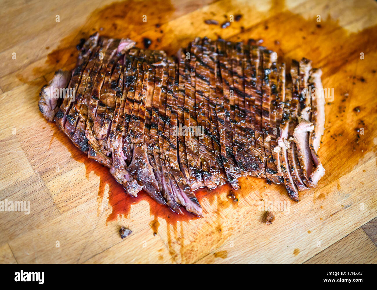 In Scheiben geschnitten Saftig gegrillte marinierte Angus Beef Flank Steak auf Holzbrett