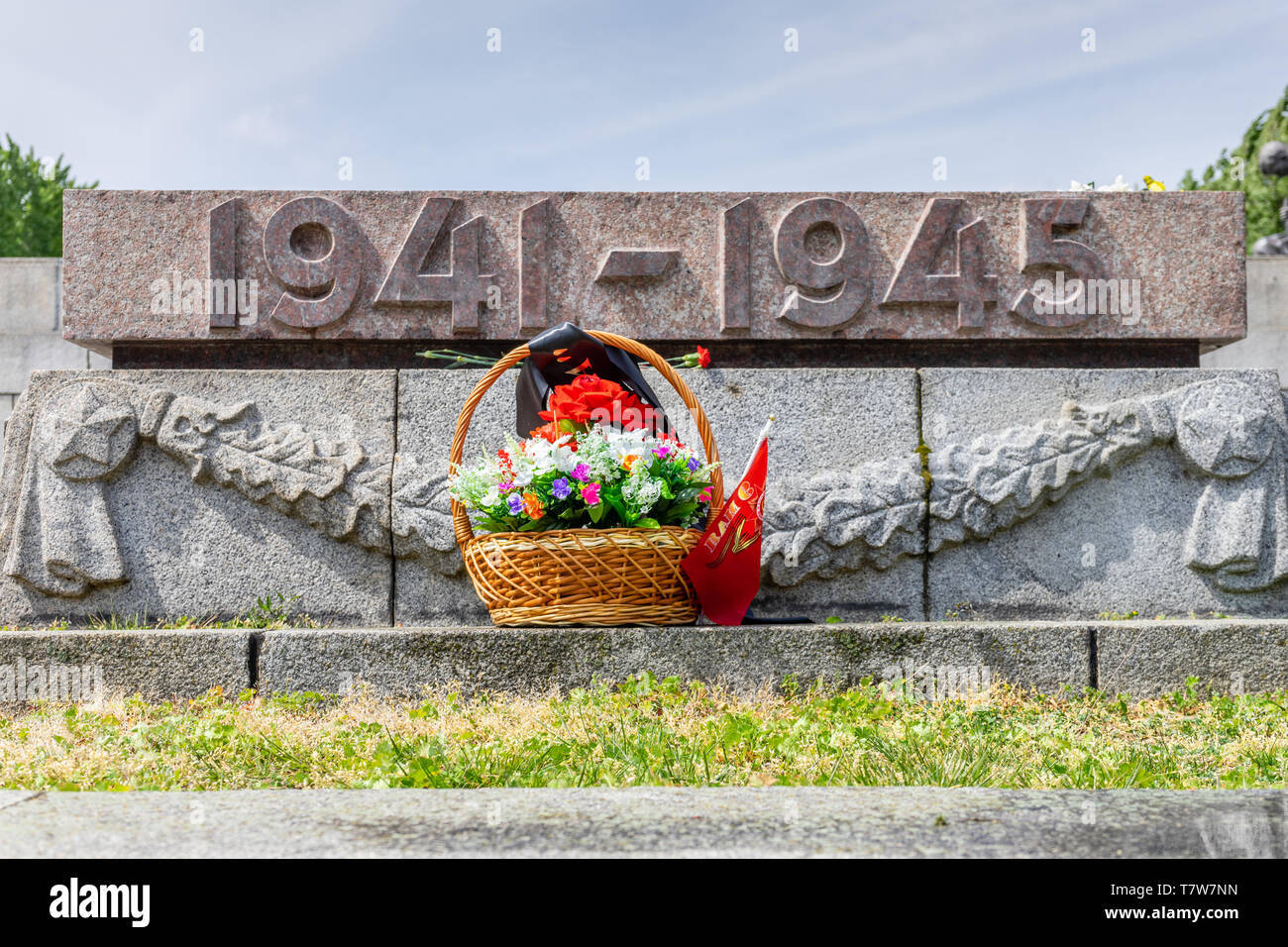Blumen vor einem Grab eines gefallenen sowjetischen Soldaten im Zweiten Weltkrieg am sowjetischen Kriegsdenkmal Berlin Treptow am Befreiungstag 8. Mai Stockfoto