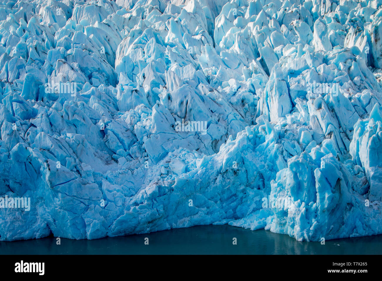 Die knik Gletscher in Alaska. Mangel an Schnee - Abdeckung setzen den Ascheregen vom nahe gelegenen Redoubt Volcano, wodurch die Albedo Effekt. Es gibt Tausende von Gletscher in Alaska und mindestens 616 von ihnen sind benannt. Zusammen sind sie verlieren 75 Milliarden Tonnen Eis jedes Jahr durch das Abschmelzen. Diese Zahl dürfte in den kommenden Jahren zu erhöhen. Mai 2015 Die heißesten in 91 Jahren war. Die blaue Farbe ist natürlich vorkommenden, sondern wird durch underexposing das Bild verbessert. Stockfoto