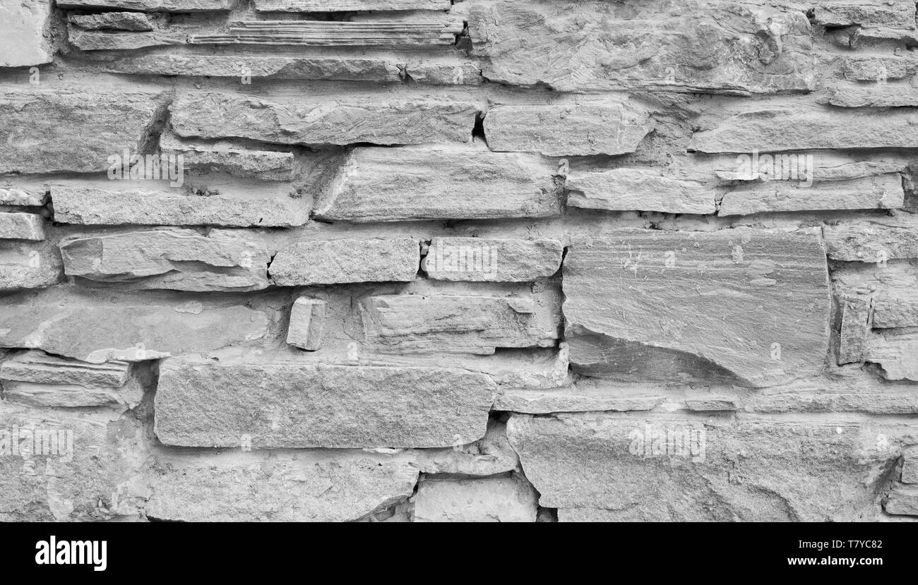 Naturstein grauer Hintergrund oder Textur. Verschiedene Steine und Beton. Stockfoto