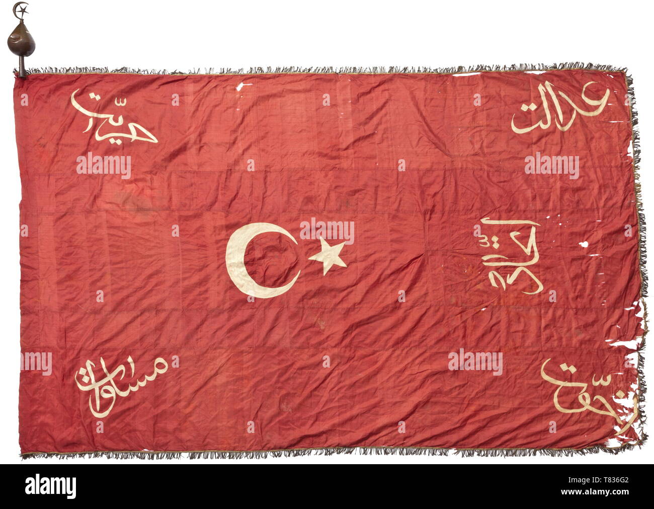 Der Flagge der Jungen Türken Bewegung ca. 1908. Feine dunkle rote Seide, fünf Stück Tuch mit gold Rand Rand auf drei Seiten (dunkel hinterlegt), Leitfaden für die Mast und Mondsichel und folgende Inschriften in Weiß Kettenstich Stickerei: "Adalet" (Gerechtigkeit), "Hürriyet" (Freiheit), bin üsavit" (Gleichheit), 'Uhuvvet" (brüderlichkeit) und 'Ittihat' (Einheit). Anzeichen von Alter und kleine Fehler. Größe ca. 250 x 160 cm. Auch eine entsprechende Flagge Finial von Blech Messing (Beulen) mit Spuren der Vergoldung. Die jungen Türken Bewegung wurde im späten 19. Jahrhundert, Additional-Rights - Clearance-Info - Not-Available gegründet Stockfoto