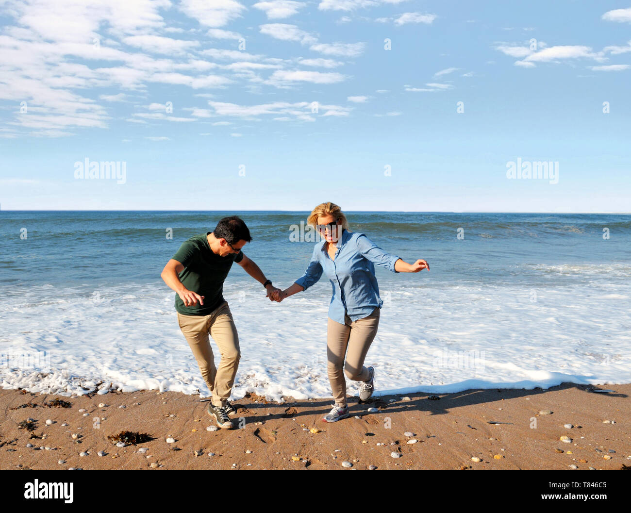 Paar spielen am Strand, Thurlestone, Devon, Vereinigtes Königreich Stockfoto