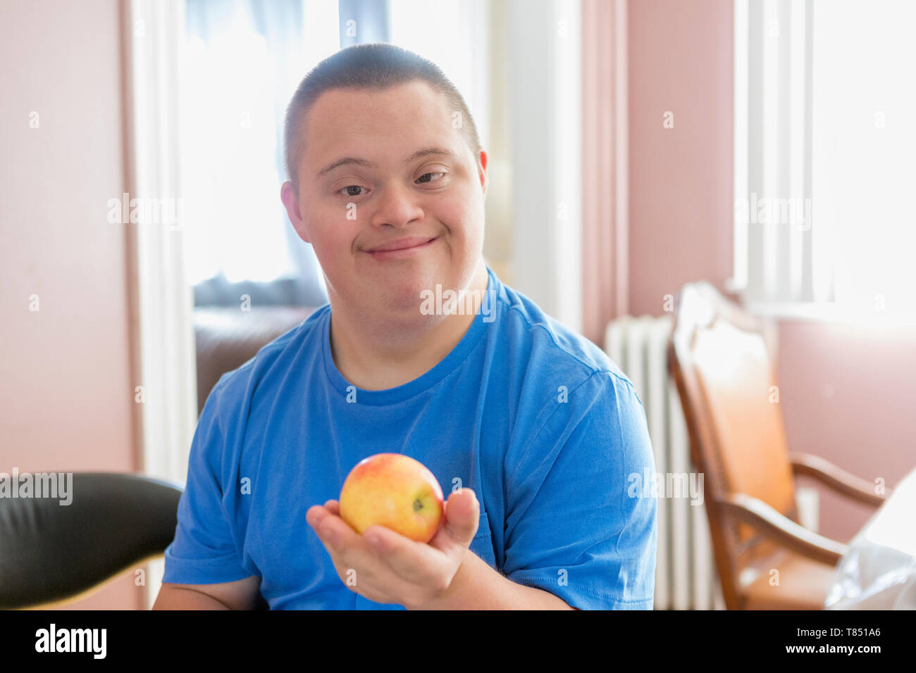 Mit Down Syndrom holding Obst jugendlich Stockfoto