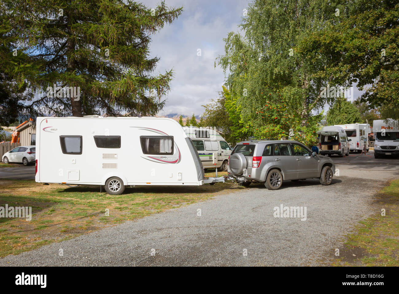 Auto einen Wohnwagen auf einem Campingplatz abschleppen und Angaben zum Ort, Neuseeland Stockfoto