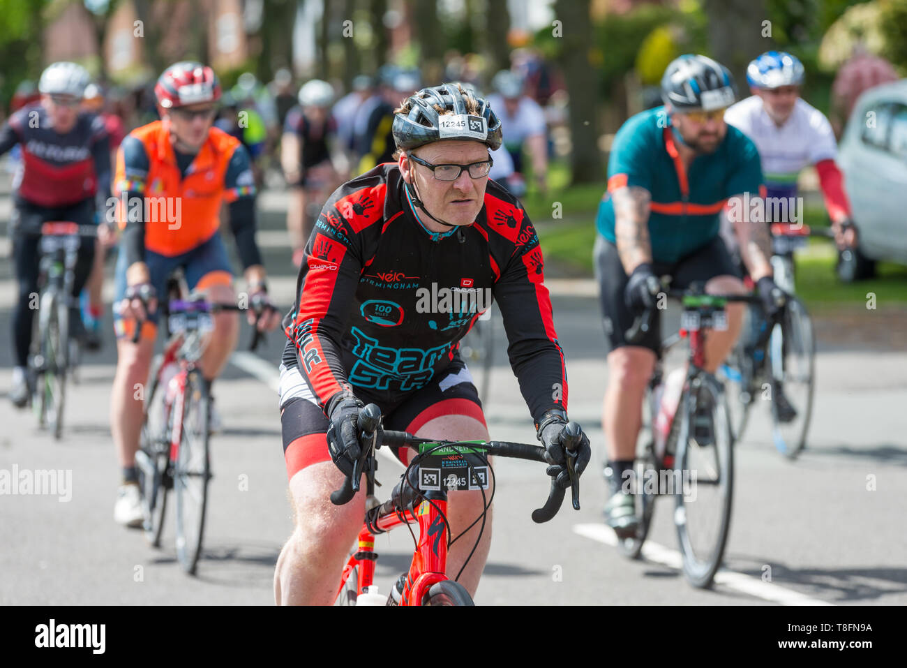 Mitfahrer im Birmingham Velo 100 Meile cycle Ride, Ride durch die grünen Vorort von Birmingham Harborne in Richtung Ziellinie Stockfoto