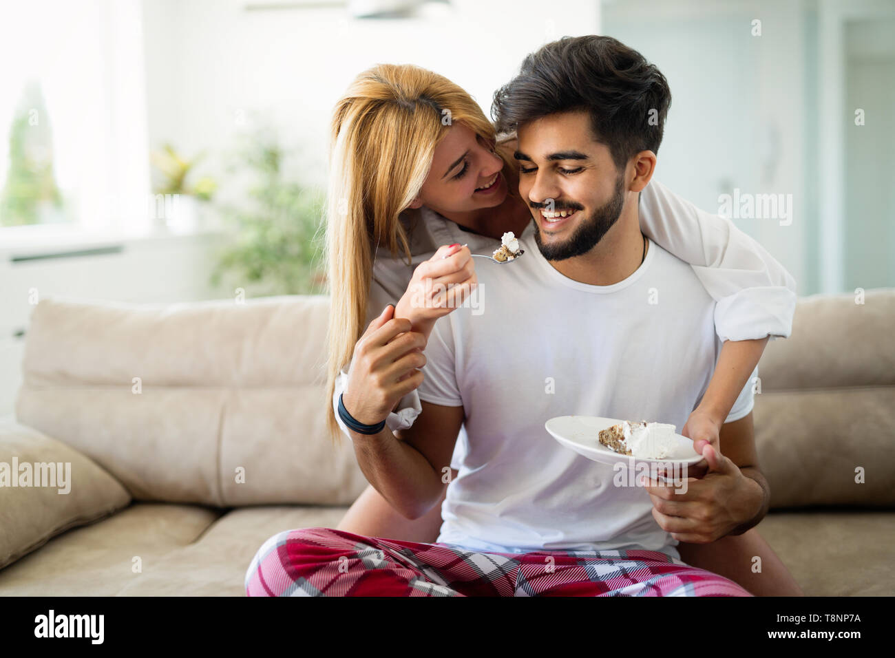 Liebevolle glückliches Paar in ihren Schlafanzügen essen Frühstück Stockfoto
