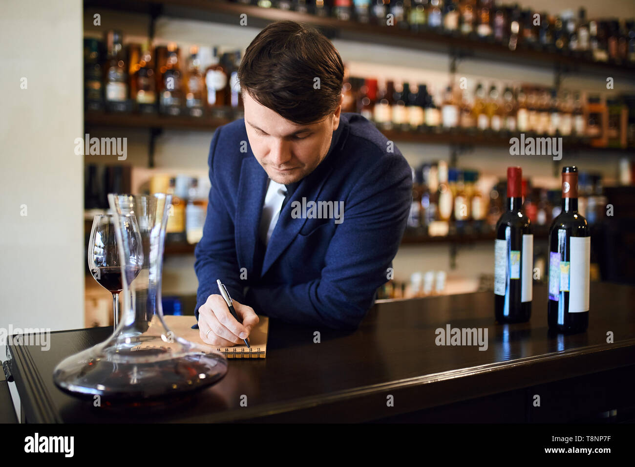 Junge modische Mann Planung die Weinkarte. bis Foto schliessen. kopieren. Die Praxis der Weinprobe Stockfoto