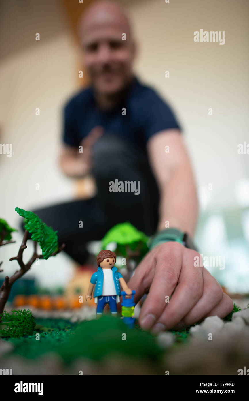 Magdeburg, Deutschland. 14 Mai, 2019. Playmobil Collector Oliver Schaffer legt eine Playmobil Figur in ein Diorama in der Jahrtausendturm im Elbauenpark. Der Künstler ist derzeit der Playmobil-Ausstellung "20 Jahre Elbauenpark', die am 18. Mai 2019 geöffnet. Tausende von PLAYMOBIL-Figuren aus der Sammlung der Hamburger kann dann in elf zeigen Landschaften bewundert werden. Die Ausstellung dauert bis zum 25. August 2019. Credit: Klaus-Dietmar Gabbert/dpa-Zentralbild/ZB/dpa/Alamy leben Nachrichten Stockfoto