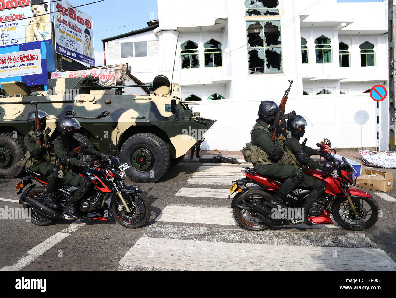 Minuwangoda, Sri Lanka. 14 Mai, 2019. Schwer bewaffnete Soldaten in Sri Lanka fahren mit dem Motorrad vor der Jumha Moschee nach einem Mob angegriffen. Mob Angriffe auf muslimische Gemeinschaften in Sri Lanka's haben eine Person getötet und Dutzende von Geschäften und Moscheen zerstört, wie kommunale Gewalt im Zuge von Ostern Bombenanschläge, die mehr als 250 getöteten Menschen verschlechtert. Credit: Pradeep Dambarage/ZUMA Draht/Alamy leben Nachrichten Stockfoto