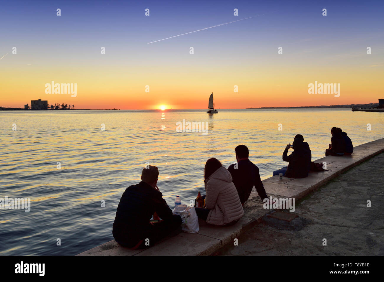 Bewundern Sie den Sonnenuntergang auf dem Fluss Tejo in einer ruhigen Abend. Belém, Lissabon. Portugal Stockfoto